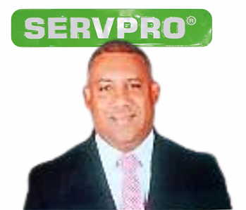 Julio, male, SERVPRO employee, cut out, against a white background, SERVPRO green sign above head