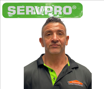 Henry, Green SERVPRO sign, employee in front, white background