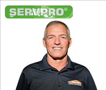 Billy Morrison standing in front of SERVPRO truck for his photo