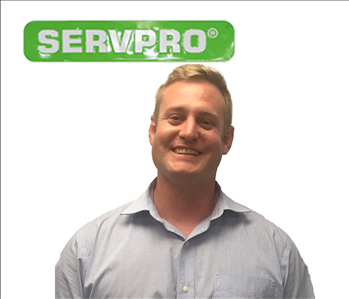 Tom, Male employee, SERVPRO green sign