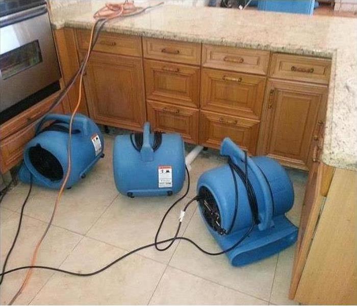 Machines drying out a floor affected by water damage
